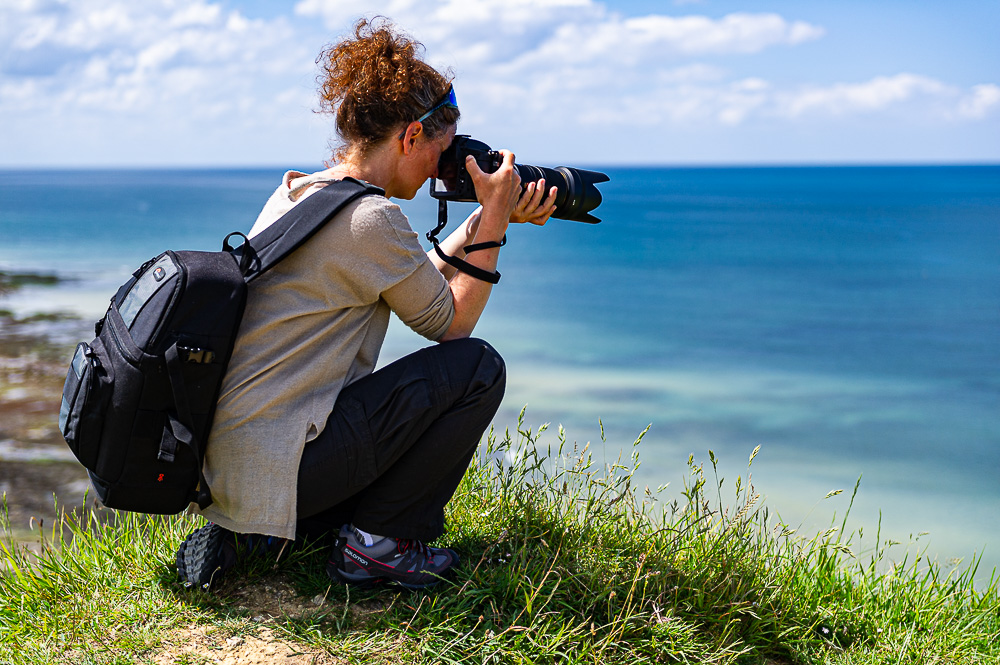 woman cliff ocean sea photographer