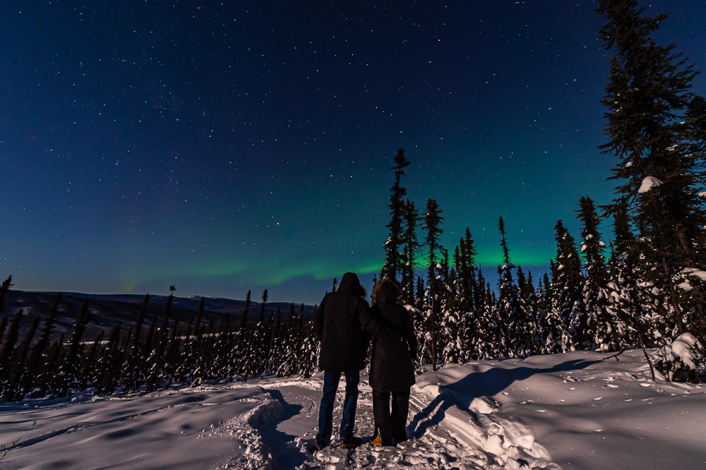 couple portrait aurora viewing winter snow